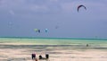 Local fishermen and visiting kite surfers at Jamibiani Beach, Zanzibar