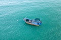 Local fishing boat on sea, drone view. Vintage colourful boat with fishing net