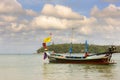 The local fishing boat on the sea and misty cloudy sky background. Royalty Free Stock Photo