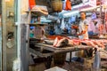 A local fishmonger preparing a variety of fresh fish. Wan Chai district, wet market.