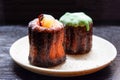 Local French dessert canele on a dark wooden background