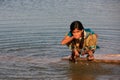 Local girl drinking from water reservoir, Khichan village, India Royalty Free Stock Photo