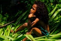 Local girl sitting in a grass in Lavena village, Taveuni Island, Fiji.