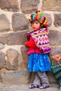 Local girl standing near Inca Fortress in Ollantaytambo, Peru