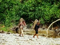 Local girls walking with firewood on the shore of Nam Song River