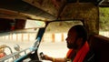 Driver drives auto rickshaw reflection of face in rearview mirror