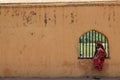 Local Indian ladies sitting on a window in Amber Amer Fort of