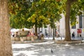 Local Italians and families relax by fountains and under trees in the Piazza della Vittoria in Brindisi, Italy.