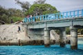 Local kids jumping off the Mouli Bridge between Ouvea and Mouli islands, Loyalty Islands, New Caledonia