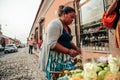 GUATEMALA - DECEMBER 28: local lady selling food on the fruit on the street to a tourist, December 28, 2018 in Antigua Guatemala, Royalty Free Stock Photo