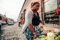 GUATEMALA - DECEMBER 28: local lady selling food on the fruit on the street to a tourist, December 28, 2018 in Antigua Guatemala, Royalty Free Stock Photo