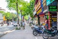 Local daily life of the street and view of busy traffic with motorbikes and vehicles in Hanoi Old Quarter, capital of Vietnam.