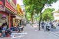 Local daily life of the street and view of busy traffic with motorbikes and vehicles in Hanoi Old Quarter, capital of Vietnam.