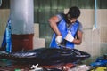 Local Maldivian Fisherman butcher a Big Tuna Fish on the Central Market of Male City Royalty Free Stock Photo