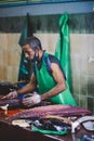 Local Maldivian Fisherman butcher a Big Tuna Fish on the Central Market of Male City Royalty Free Stock Photo