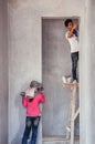 Local male and female Asian construction labours working in construction site