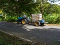 Local man drives farm tractor truck on road Royalty Free Stock Photo