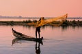 Local man fishing with a net at sunset, Amarapura, Myanmar