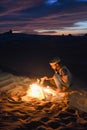 Local man lighting a fire in white desert Royalty Free Stock Photo