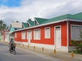 Local man on a motorbike riding along colorful buildings