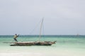 Local man pushing traditional Dhow boat, Zanzibar Royalty Free Stock Photo