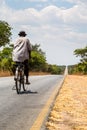 Local man riding on a bike on a desolated road