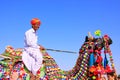 Local man riding a camel at Desert Festival, Jaisalmer, India