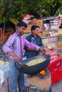 Local man roasting peanuts at Johari Bazaar in Jaipur, India.