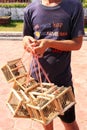 Local man selling birds near Pha That Luang