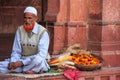 Local man selling flowers in the courtyard of Jama Masjid in Fat
