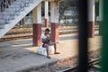 A local man sits on a couple of rice bags at the platform of the circle train