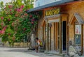 Local man sits in front of a touristy mango shop and looks down the empty street Royalty Free Stock Photo