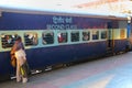 Local man standing by the train at Jaipur Junction railway station in Rajasthan, India.