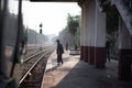 A local man in traditional longyi at a platform stop with the circle train