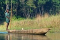 Local man traveling by rowboat at wild river in Chitwan National Park, Nepal Royalty Free Stock Photo