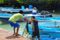 Local man unloading tuna at the fish market at Puerto Ayora, San