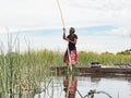 Local man working on Mokoro to deliver tourists and campers across the rivers of the Delta Okawango, Botswana Royalty Free Stock Photo