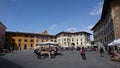 A local market on Piazza dei Cavalieri, Knights' Square, with tourists growing the stalls and Palazzo della Carovana Royalty Free Stock Photo