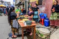 Local Maya women make tortillas in the street, Santiago Sacatepequez, Guatemala Royalty Free Stock Photo