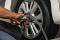 Local Mechanician Using Tools to Change Customer Tyre, Automotive Tyre Service Business