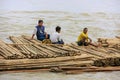 Local men floating on a bamboo raft down Ayeyarwady river near M Royalty Free Stock Photo