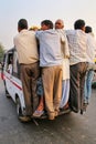 Local men hanging off the back of a truck at Kinari Bazaar in Ag