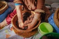 Local Moroccan woman hand-kneading argan oily paste to extract Argan oil.