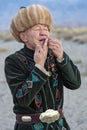 Local musician in traditional costumes playing Jew`s Harp, Issyk Kul Lake, Kyrgyzstan