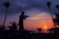 Local musicians, Asian man playing violin on the coconut beach with million stars galaxy