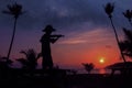 Local musicians, Asian man playing violin on the coconut beach with million stars galaxy