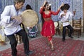 Local musicians playing musical instruments, singing and dancing, in Khiva, Uzbekistan