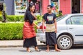 Local native indigenous Polynesian smiling teens, girl and boy, in traditional closing - skirts of taovala and tupenu. Tonga.