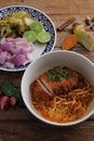 Local northern Thai food Egg noodle curry with fried pork on wood background Royalty Free Stock Photo