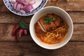 Local northern Thai food Egg noodle curry with fried pork on wood background Royalty Free Stock Photo